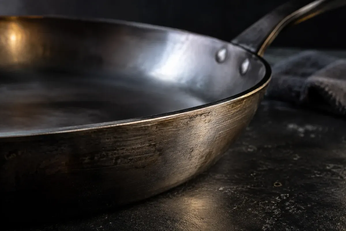 Close up of a carbon steel pan showing its metal thickness