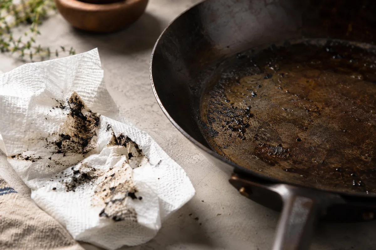 Black residue from a carbon steel pan on a paper towel