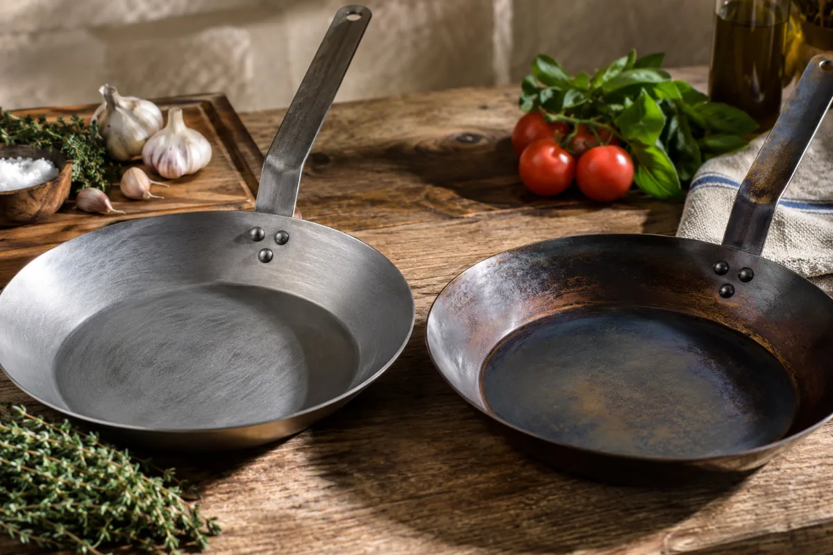Raw versus seasoned carbon steel pan showing the natural non-toxic surface